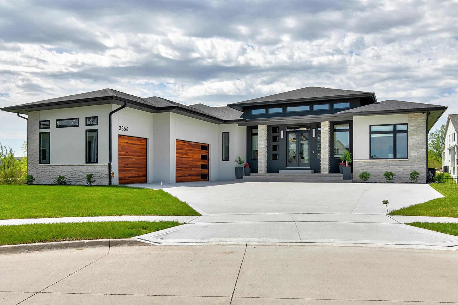 3856 NW 177th Ct — front exterior with wood-accent garage doors
