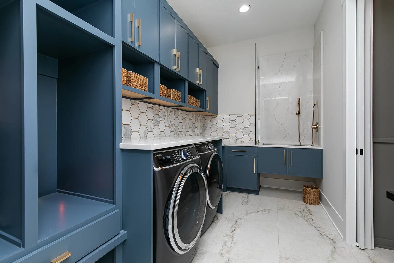 3856 NW 177th Ct — laundry room with custom blue cabinetry