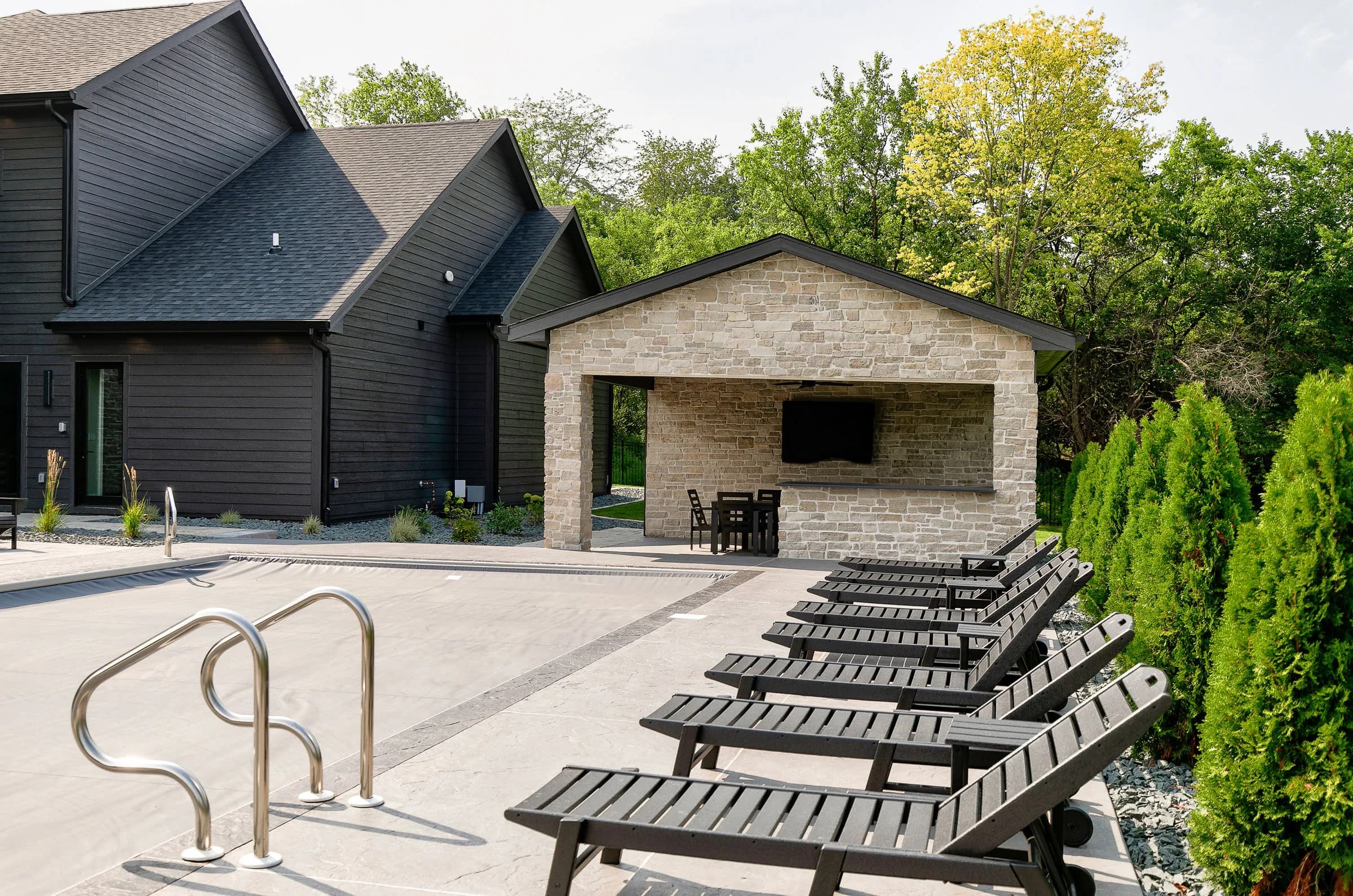 Forest Pointe — poolside seating and rear elevation