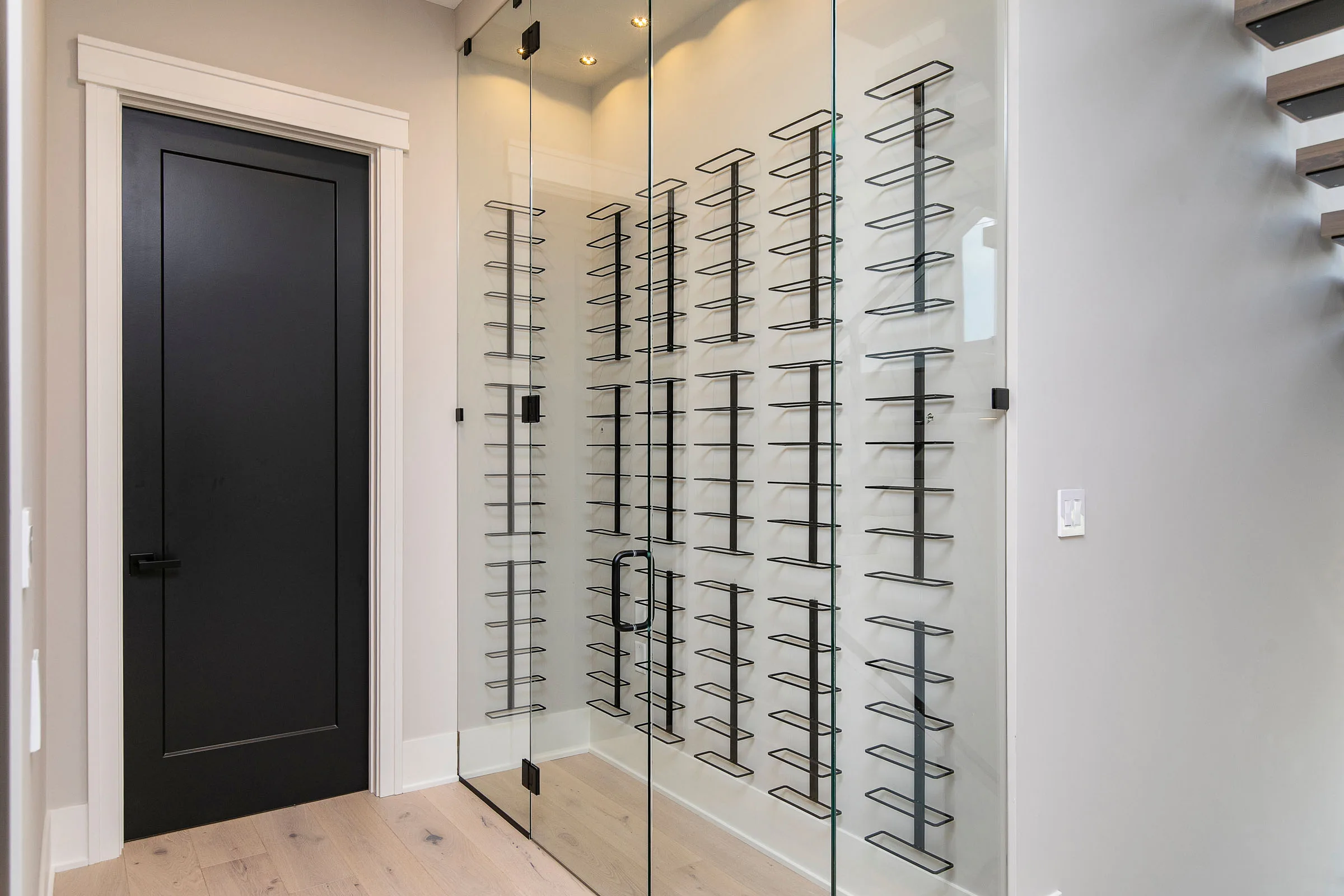 Glass-walled wine display in a MIR Homes build
